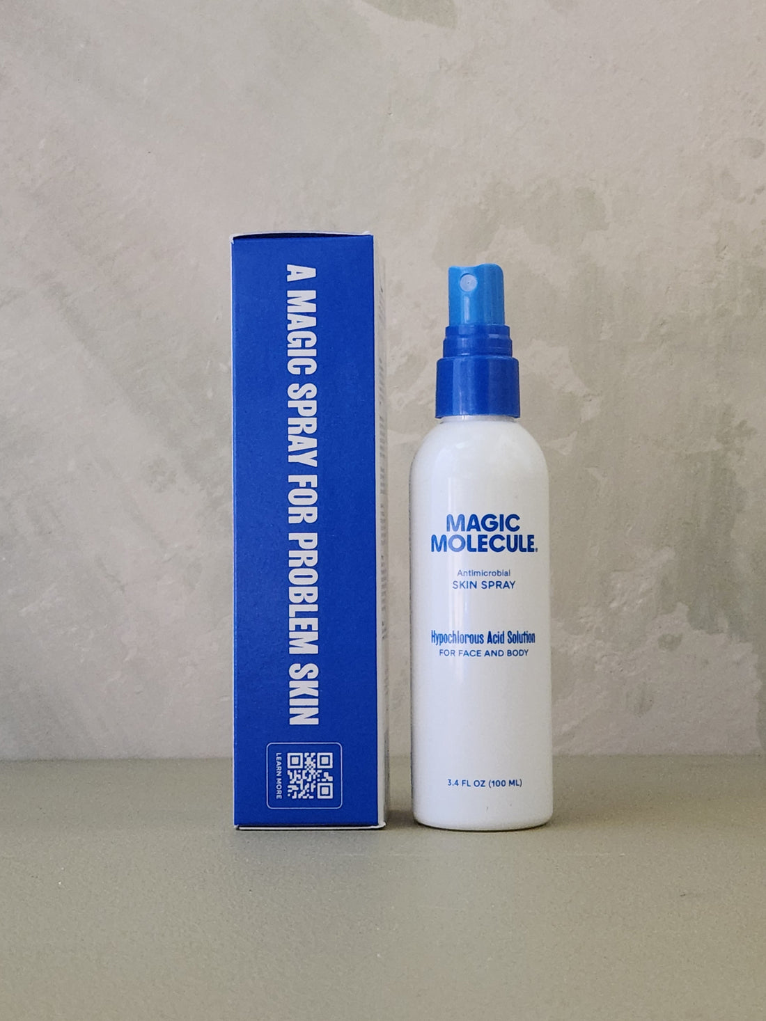 White spray bottle with blue nozzle and blue box labeled &