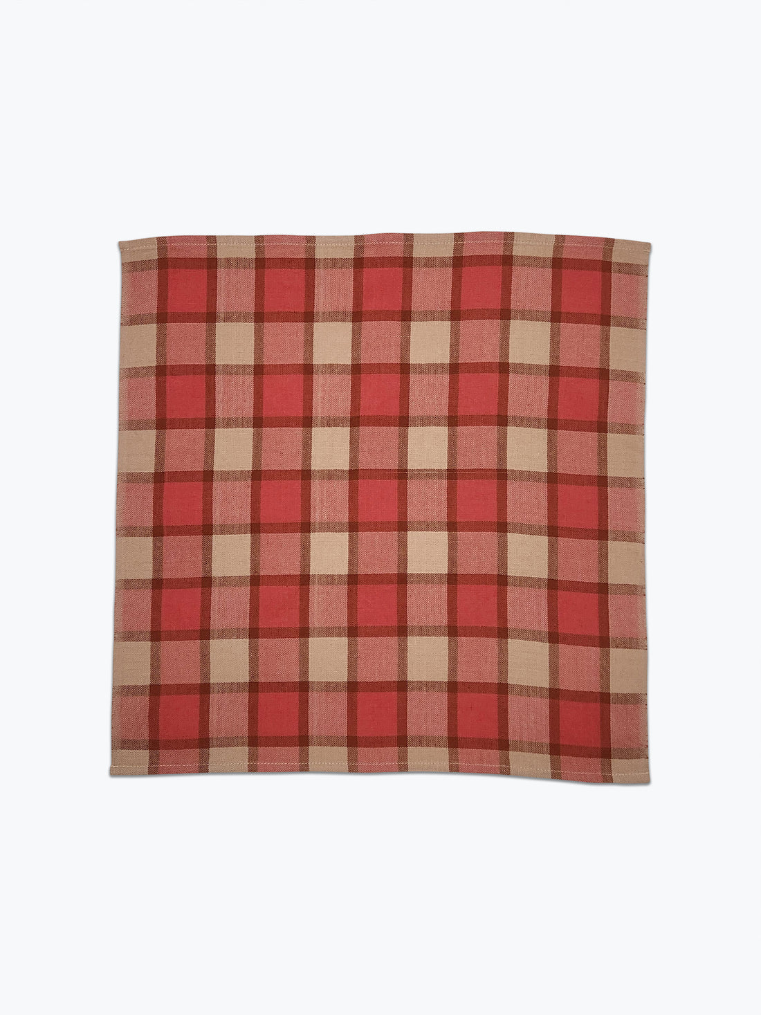 Red and beige plaid fabric on a white background
