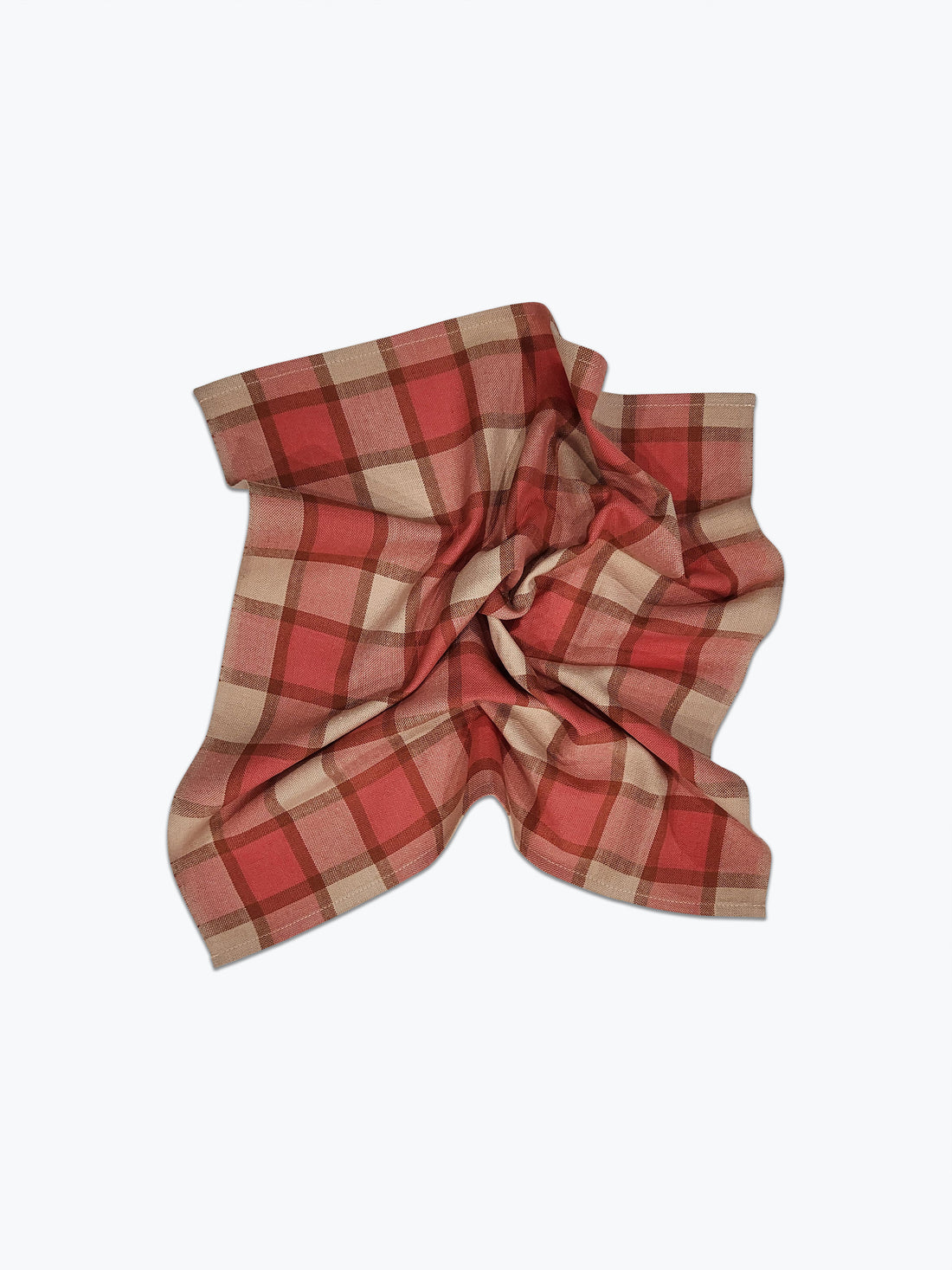 Red and beige plaid fabric on a white background