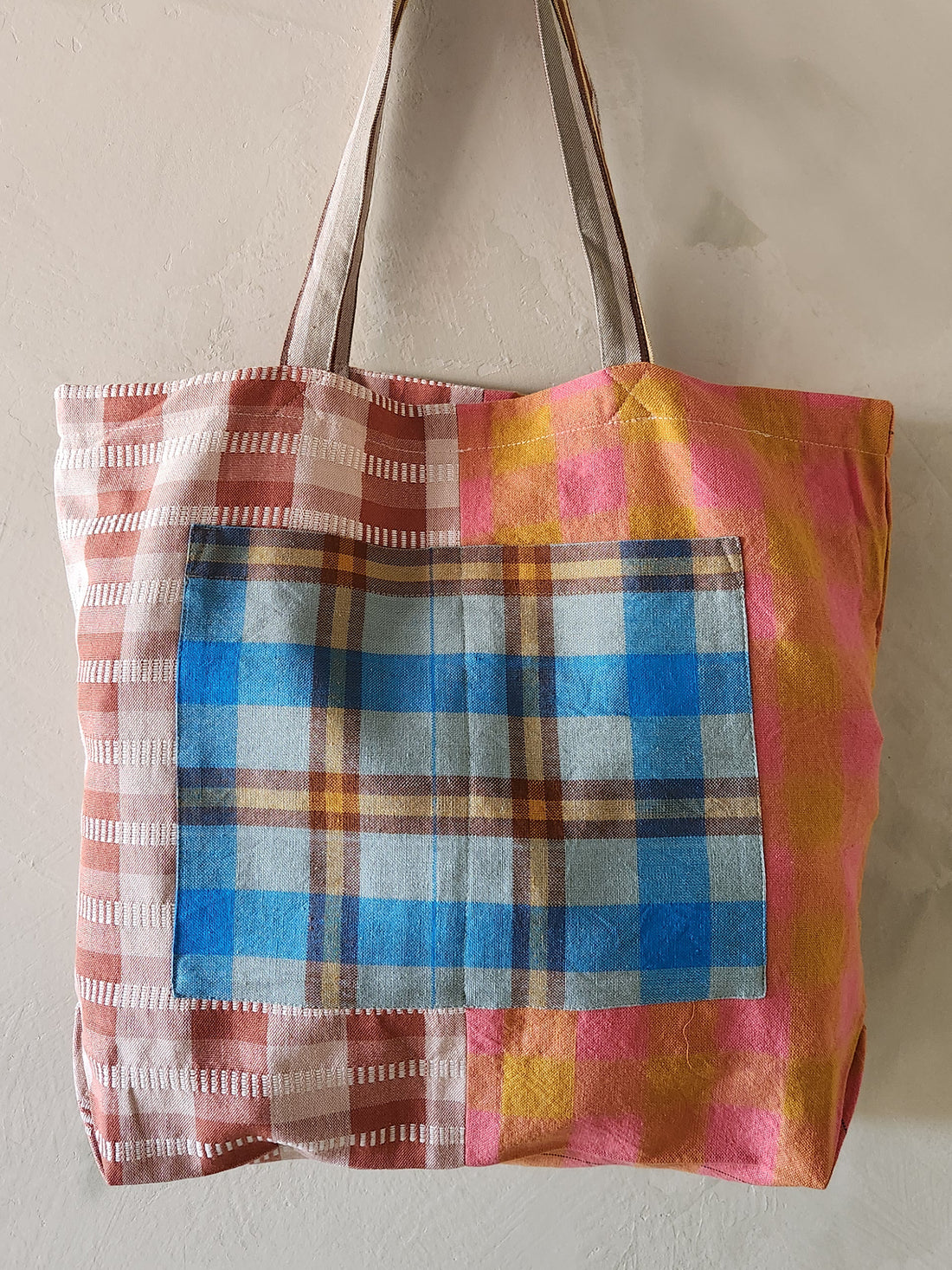 Colorful plaid tote bag with a plain background