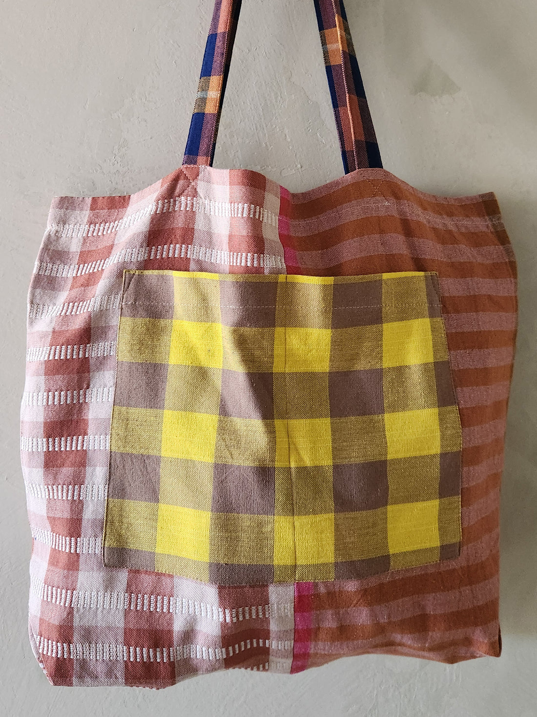 Tote bag with plaid pattern on a plain background
