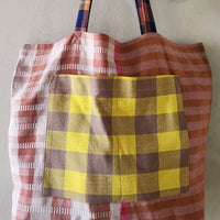 Tote bag with plaid pattern on a plain background