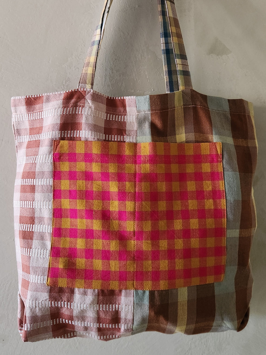 Plaid patterned tote bag on a plain background