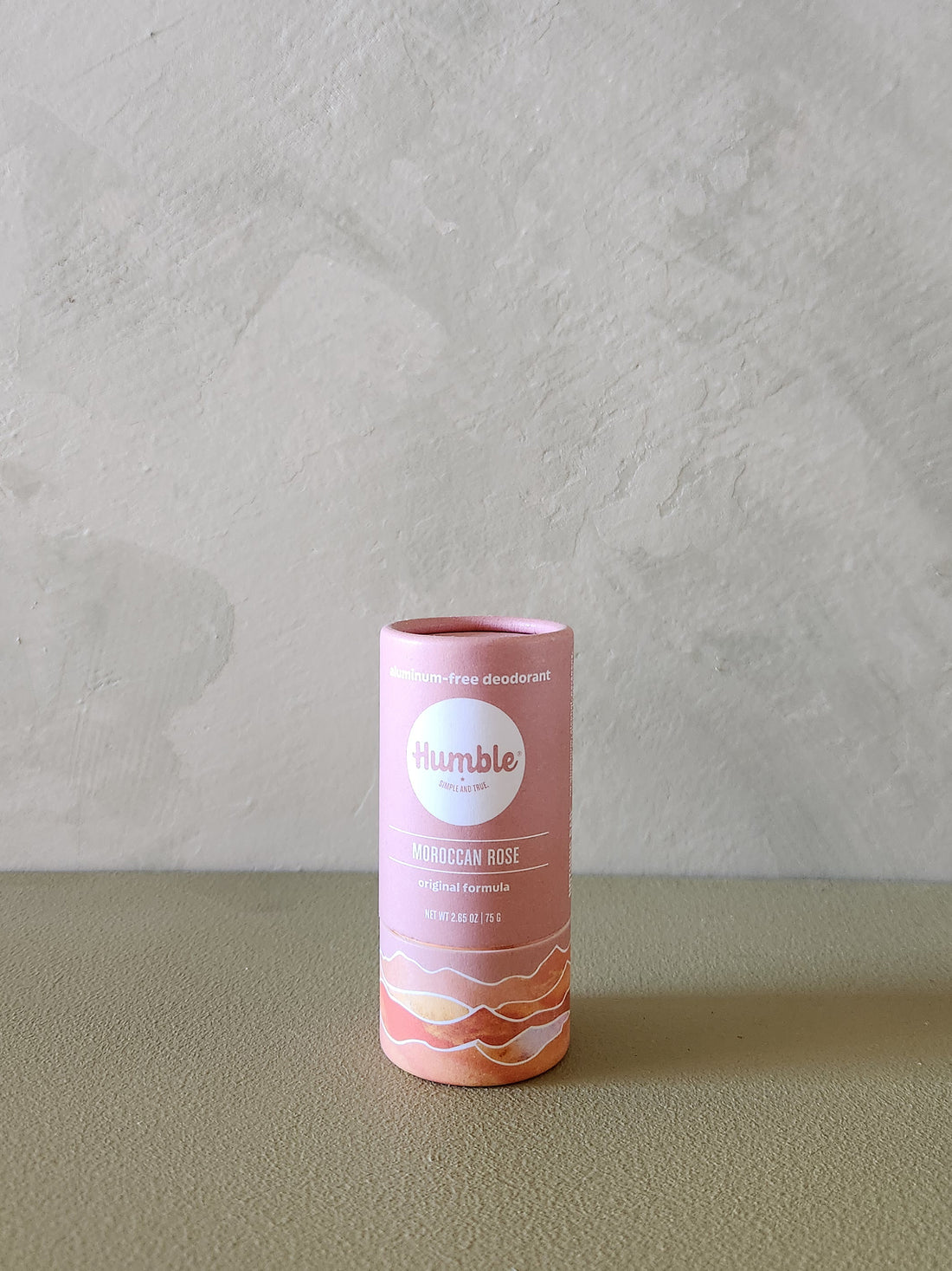 Pink cylindrical product packaging with &