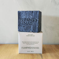 an oversized block of black handmade soap scented with lavender and other herbs.