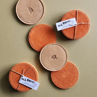 set of 4 suede coasters, 1 side orange and the other side tan branded with an AR.