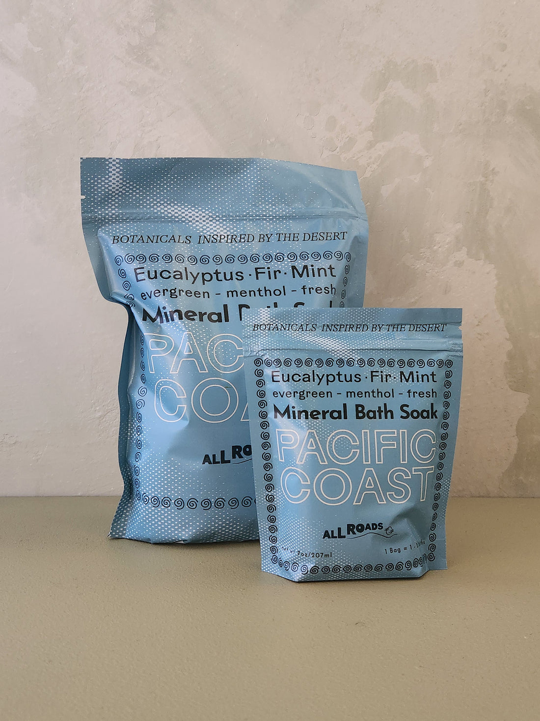 Two packages of Pacific Coast Mineral Bath Soak on a neutral background