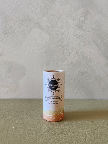 Cylindrical product packaging with 'humble' branding on a neutral background