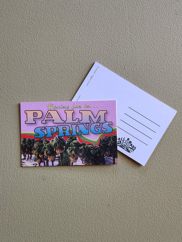 Postcard with 'Palm Springs' design on a gray surface