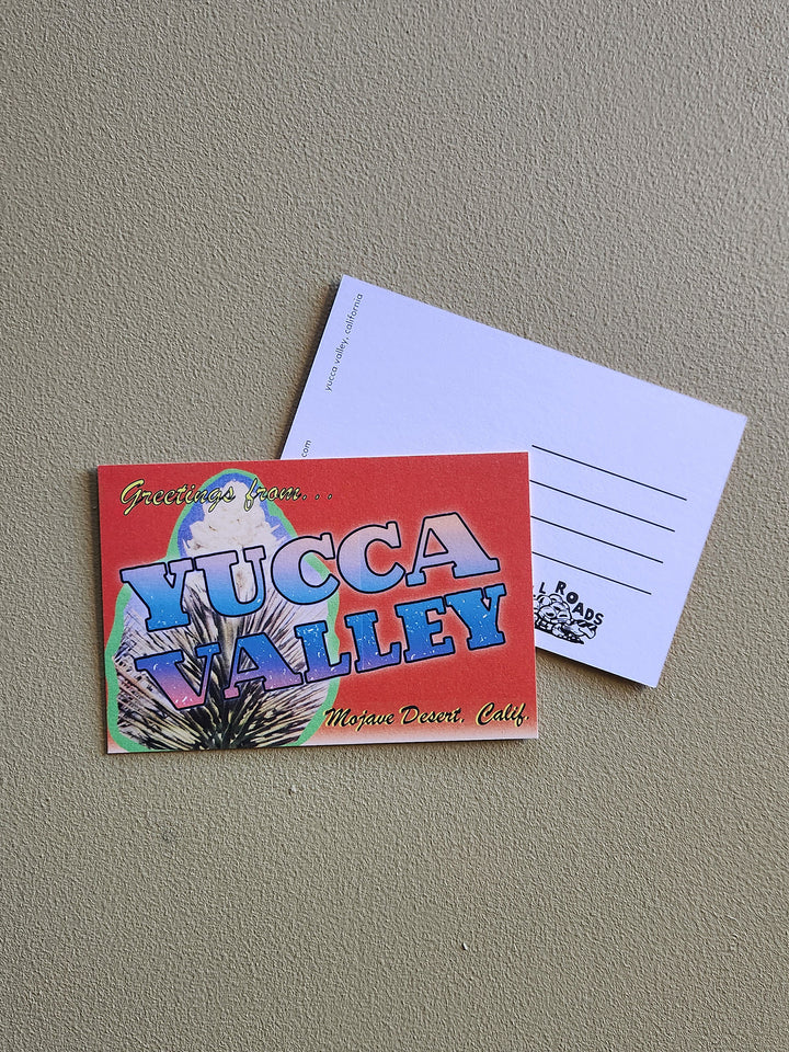 Colorful postcard with 'Yucca Valley' text on a gray surface
