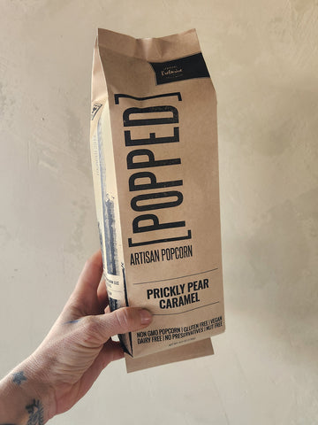 a bag of popcorn coated in prickly pear caramel.