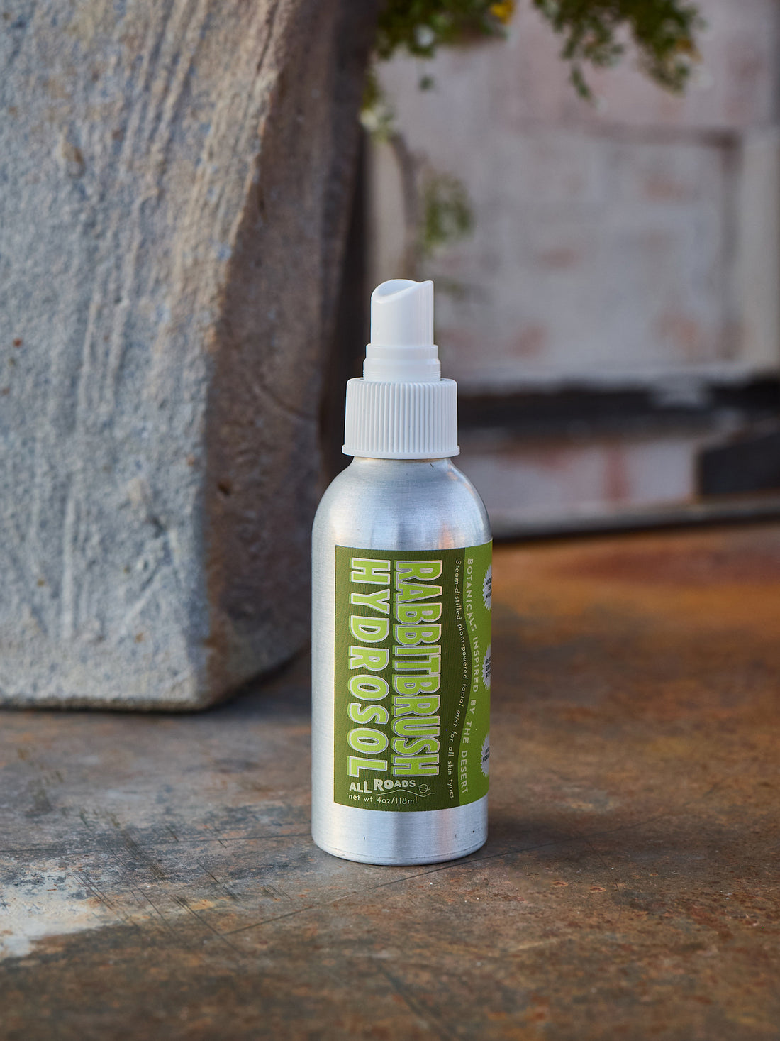 Bottle of Rabbitbrush Hyrdosol on a stone surface with a blurred natural background