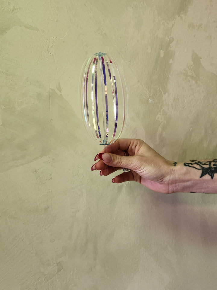 Iridescent rainbow spinner toy.