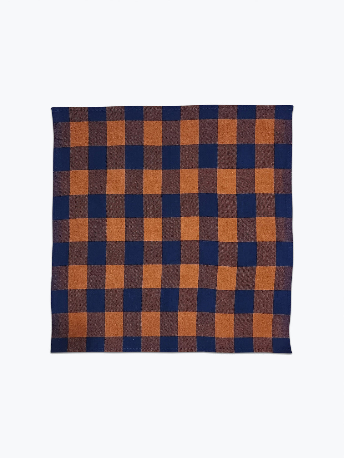 Plaid napkin in saddle brown and navy blue. 