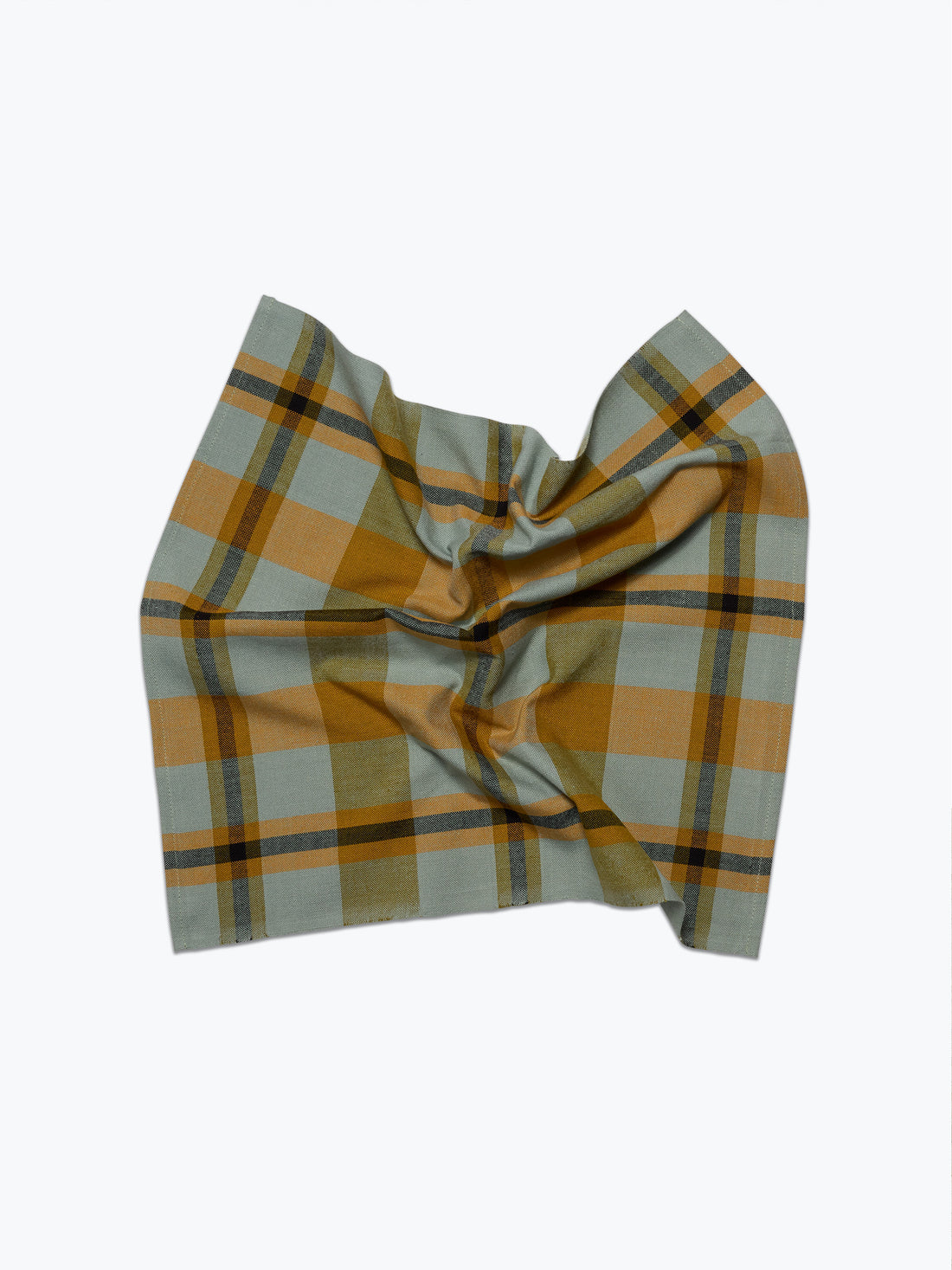 A napkin with a muted green and mustard yellow plaid pattern, styled in a loose knot against a plain white background.