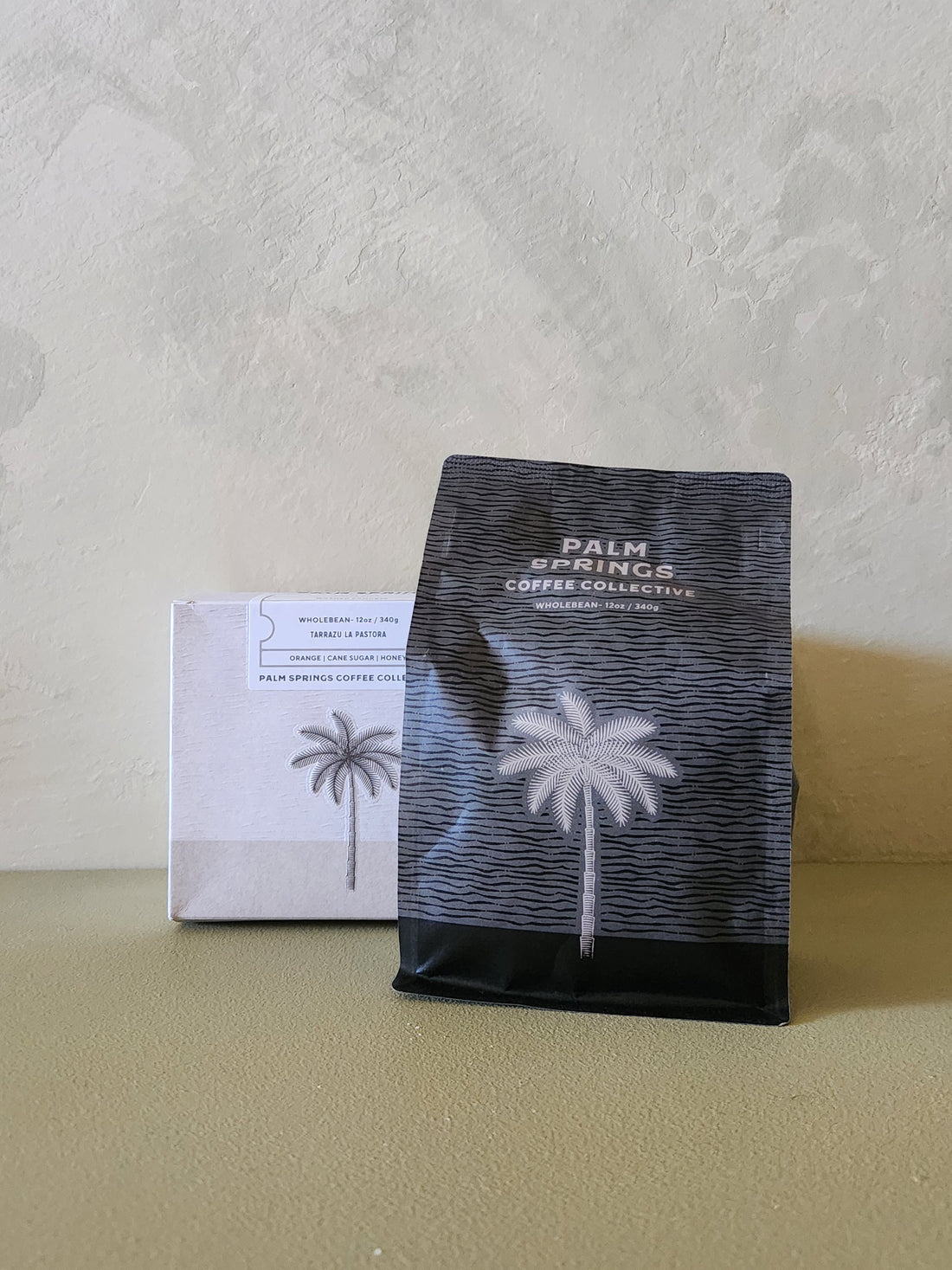 Coffee package with palm tree design on a neutral background