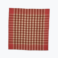 Pink and beige checkered fabric on a white background