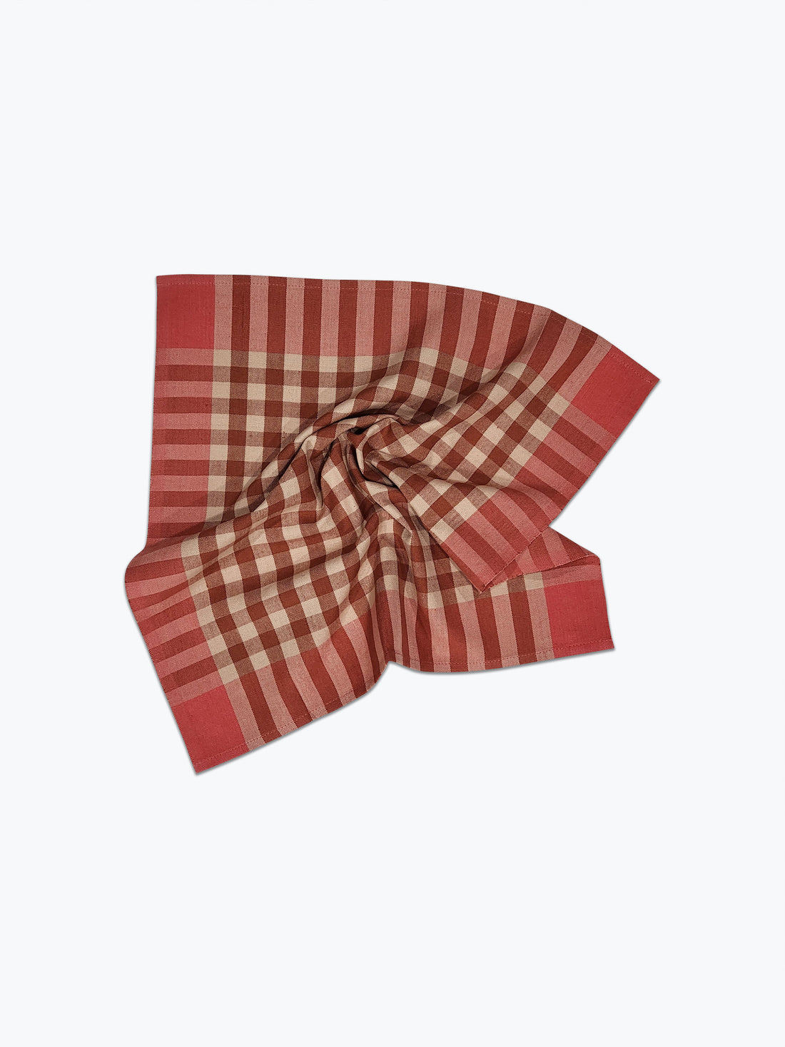 Pink and beige checkered fabric folded on a white background