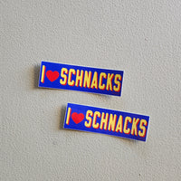 Two 'I ❤️ SCHNACKS' stickers on a gray background