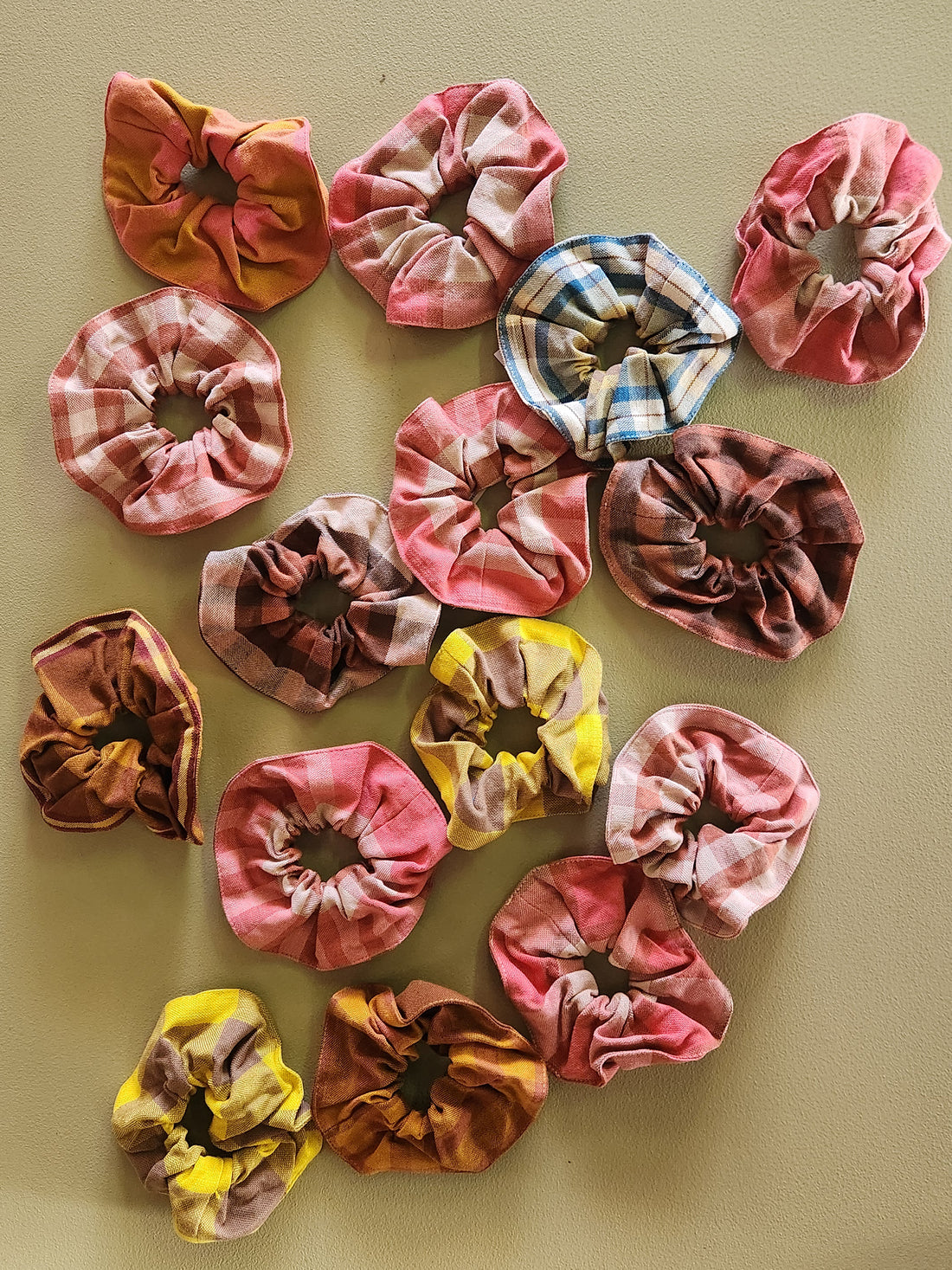 Collection of colorful scrunchies on a beige background
