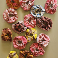 Collection of colorful scrunchies on a beige background