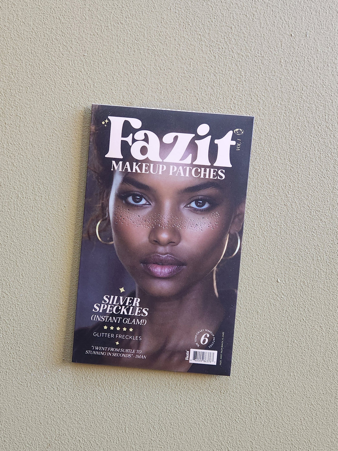 Fazit makeup patches packaging with a model on a beige wall
