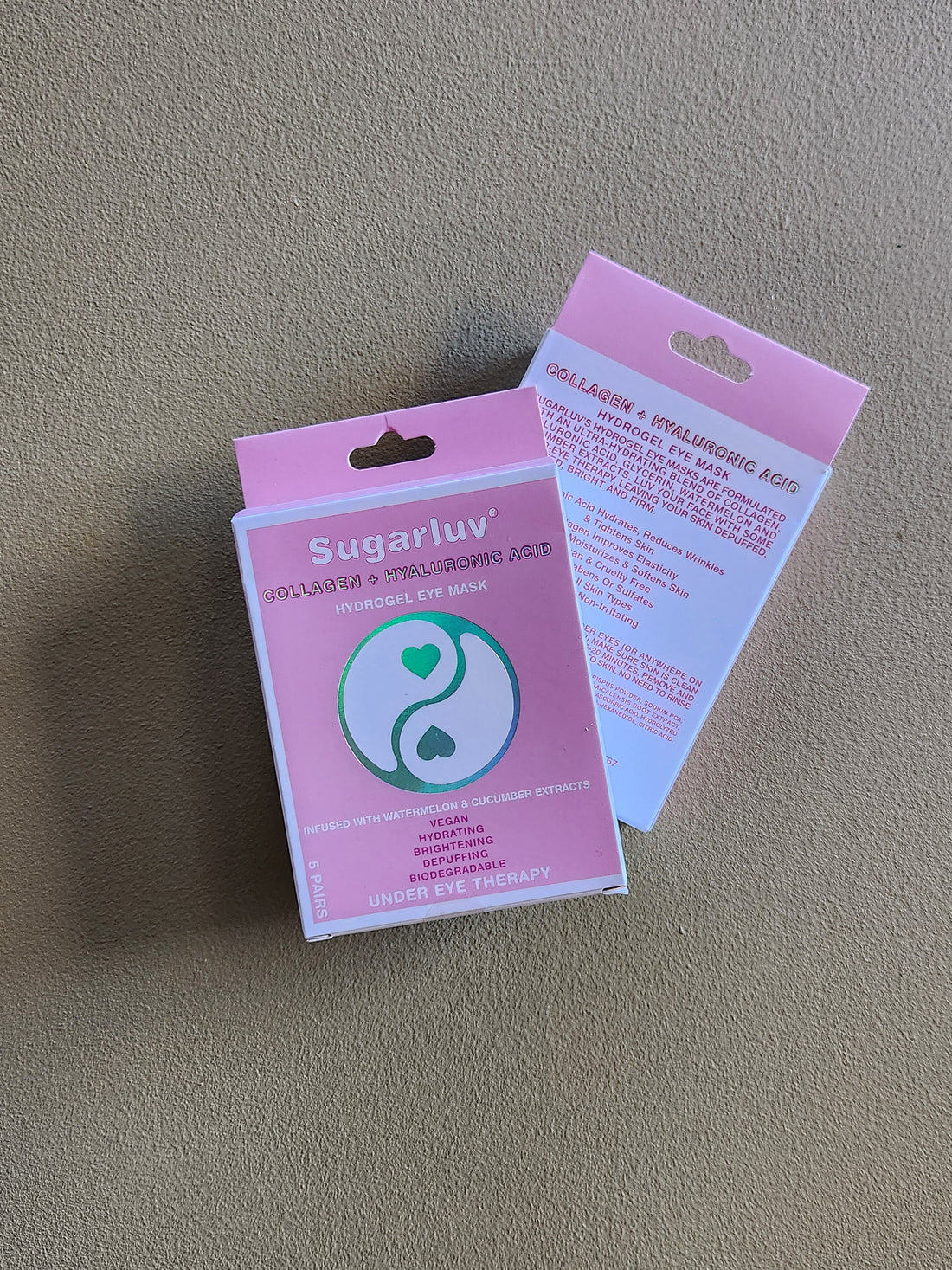 Pink packaging of Sugarluv hair removal product on a gray surface