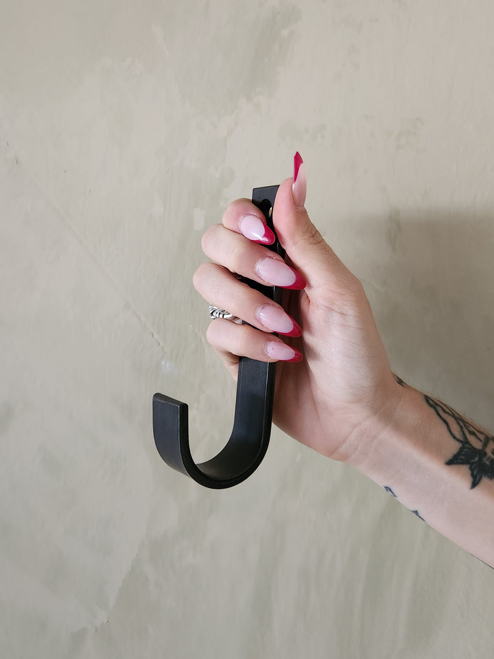 An oversized black steel J hook