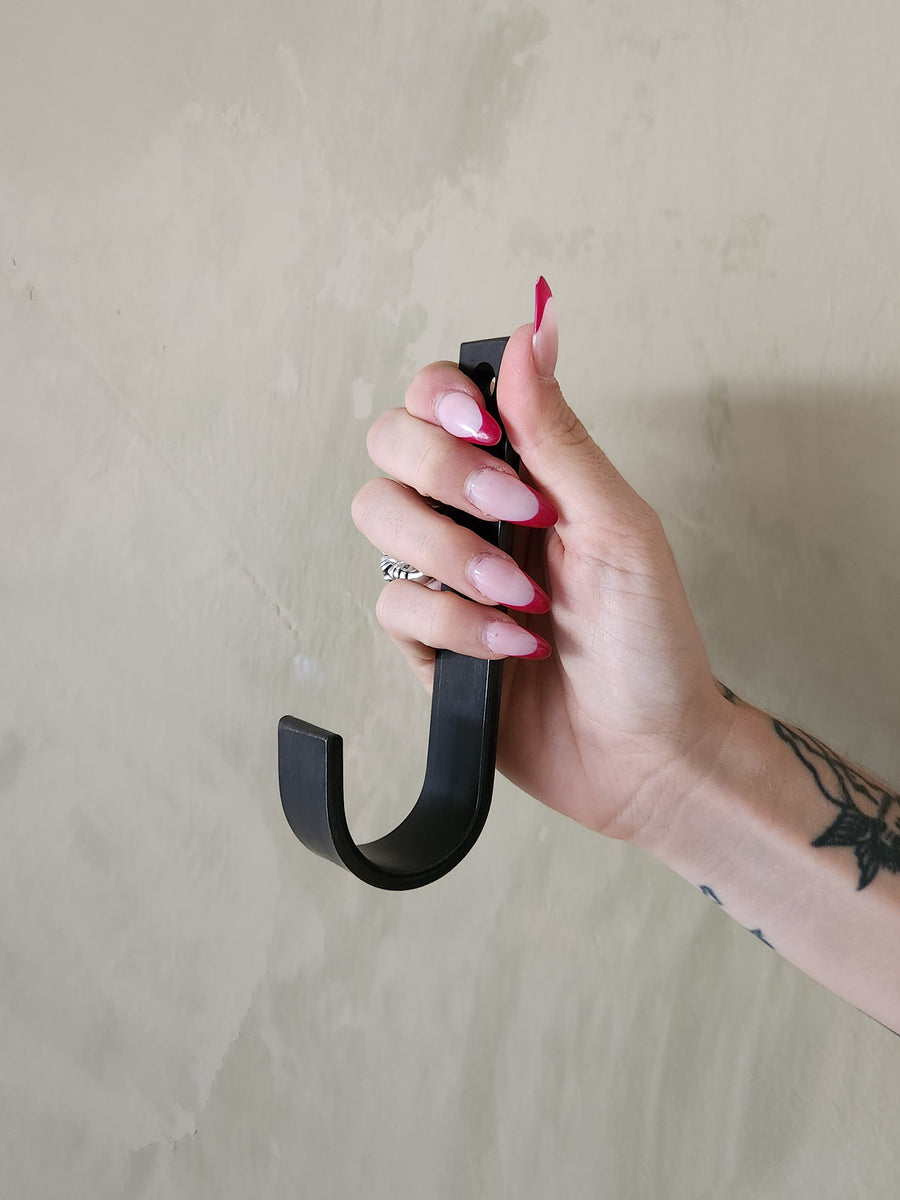 An oversized black steel J hook