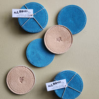 Set of 4 suede coasters, 1 side teal the other side tan with an AR brand.