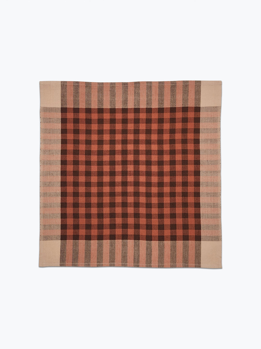 Plaid blanket with red and brown pattern on a white background