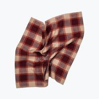 Plaid fabric with purple and beige pattern on a white background