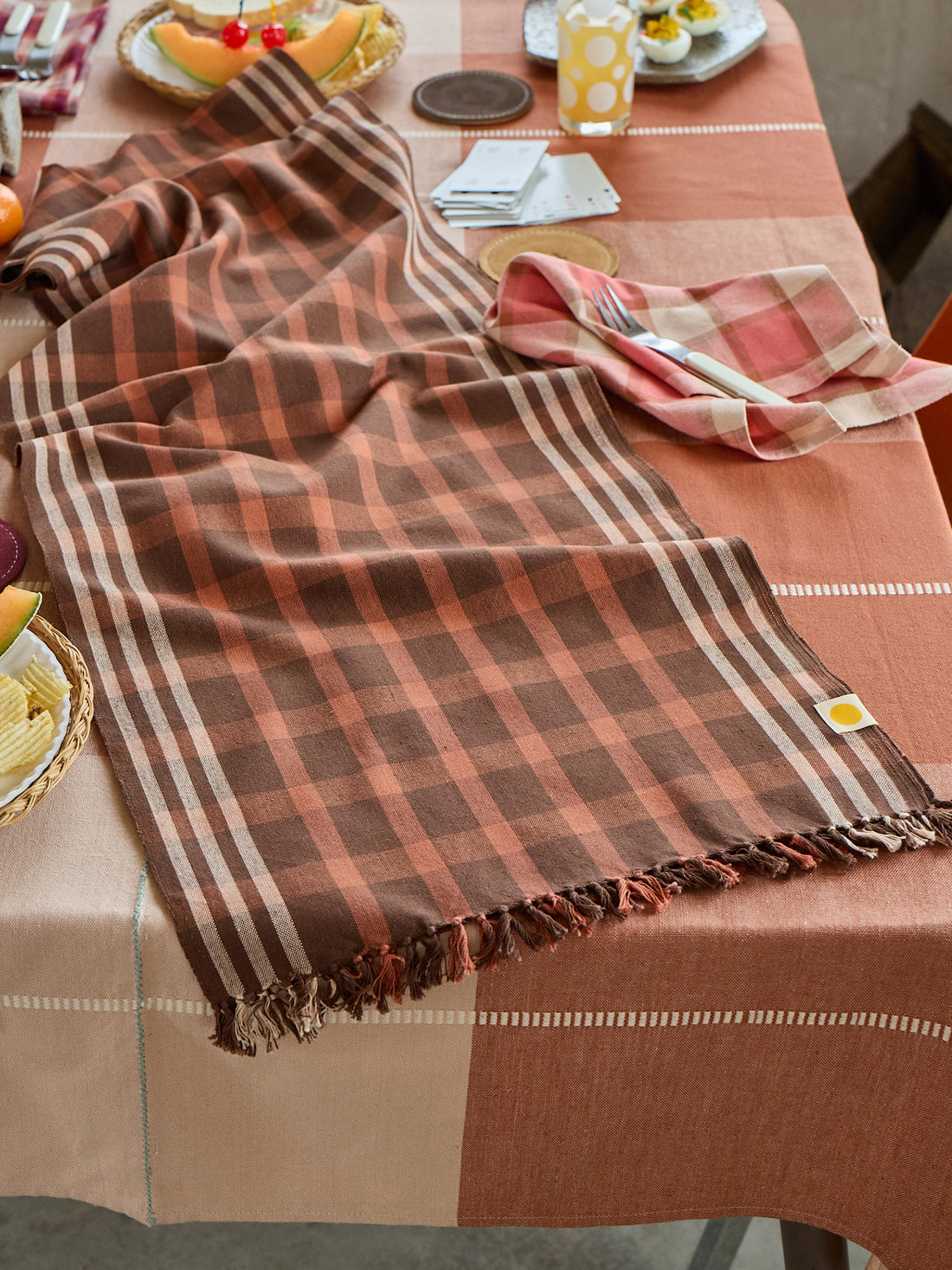 Plaid tablecloth on a dining table with a checkered pattern