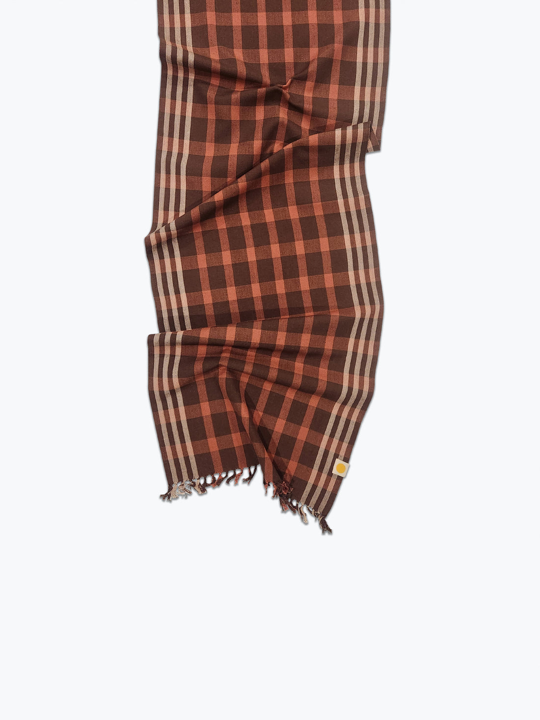 Brown and salmon checkered scarf with frayed edges on a white background