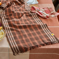 Plaid tablecloth on a dining table with a checkered pattern