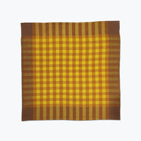 Plaid fabric with yellow and brown colors on a white background