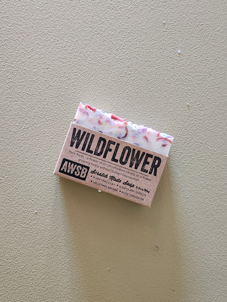 Bar of soap with 'Wildflower' and 'AWSB' branding on a beige background
