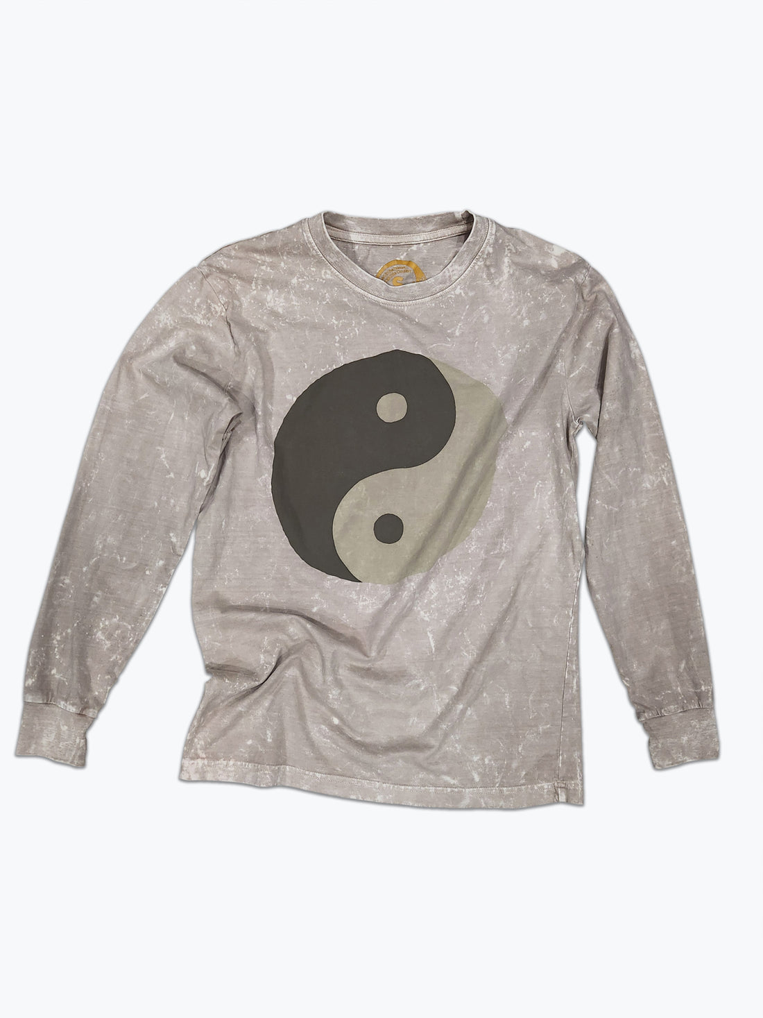 A tan long sleeved t-shirt with a large tonal brown ying yang screen print on the front.