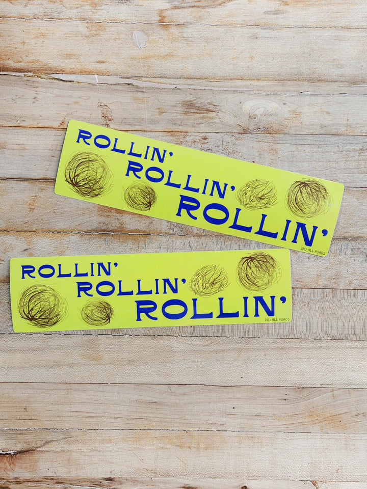 Bumpter sticker that says "rollin', rollin' rollin'" The sticker has drawings of blowing tumbleweeds. 2.5" x 9.5" in size.