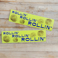 Bumpter sticker that says "rollin', rollin' rollin'" The sticker has drawings of blowing tumbleweeds. 2.5" x 9.5" in size.
