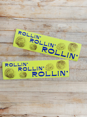 Bumpter sticker that says "rollin', rollin' rollin'" The sticker has drawings of blowing tumbleweeds. 2.5" x 9.5" in size.